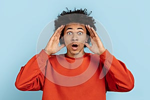 Black man with hands on head in disbelief photo