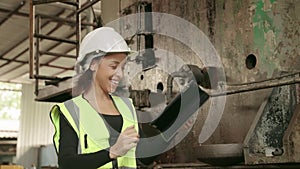 African American factory worker Technician woman looking at the tablet and jumping for joy. After the success of her work projects