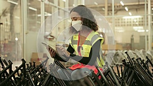 African American factory worker Technician woman with tablet check or maintenance the workpiece in factory and look happy with her