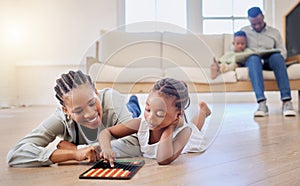 African american family bonding in the lounge together at home. Black mother playing a game with her daughter while a