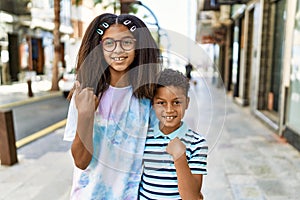African american family of bother and sister standing at the street pointing finger to one self smiling happy and proud