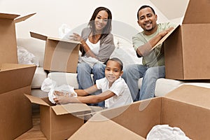 African American Family With Boxes Moving Home