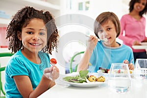 African American Family Eating Meal At Home Together