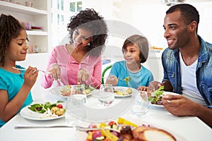 African American Family Eating Meal At Home Together