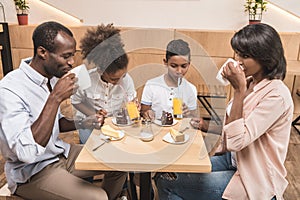 african-american family eating tasty desserts