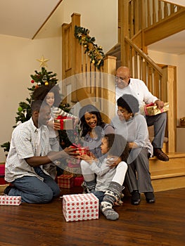 African American family exchanging Christmas gifts