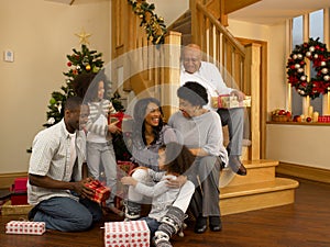 African American family exchanging Christmas gifts