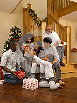 African American family exchanging Christmas gifts