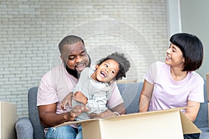 African American family,  father, Asian mother and 5-year-old daughter, they are happy together From moving or relocation to a new