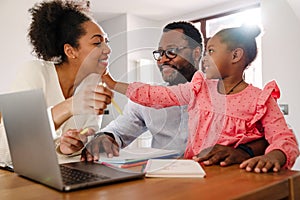 African american family with girl drawing in notepad at home