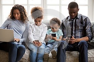 African american family with kids using devices at home