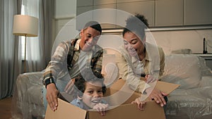 African American family moving in new home relocation happy parents unpacking parcel surprise funny joyful son little
