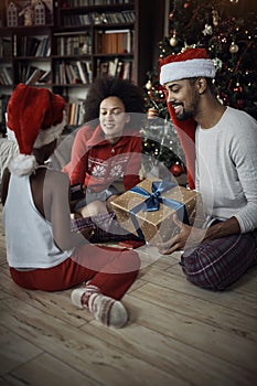 African American family opening presents on Christmas morning