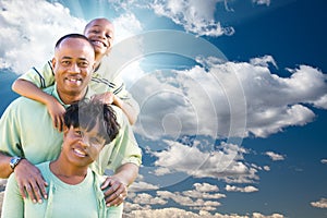 African American Family Over Blue Sky and Clouds