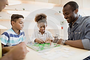 african-american family playing board game