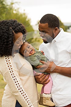 Happy African American family with their baby.