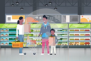 African American Family Shopping At Supermarket And Buying Products Over Shelves At Grocery Consumerism Concept