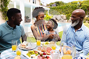 African american family spending leisure time together at backyard during brunch