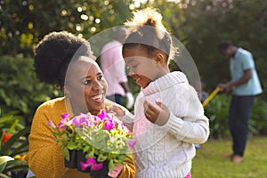 African american family spending time together in the garden and gardening