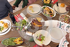 African american family spending time together having christmas meal