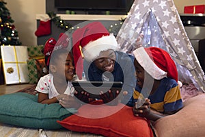 African american family spending time together and lying in tepee