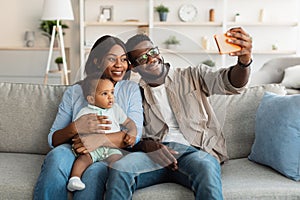 African american family taking selfie together at home