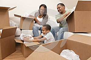 African American Family Unpacking Moving Boxes