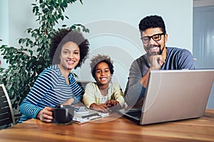 African american family using laptop in the living room