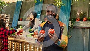 African american farmer presenting fresh eco produce