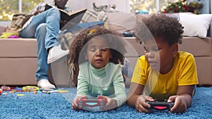 African-American father babysit children playing video game. Realtime