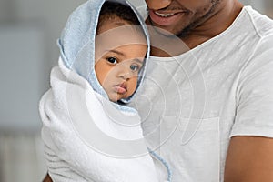 African American Father With Cute Infant Baby Wrapped In Towel After Bath