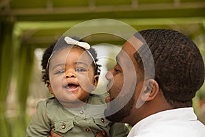 African American father holding his daughter.