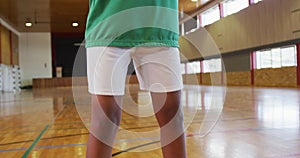 African american female basketball player dribbling and shooting with ball