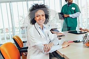 African american female doctor on hospital looking at camera smiling