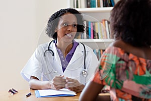 African american female doctor talking to patient
