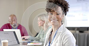 African american female doctor using laptop in meeting room with copy space, slow motion