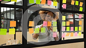 African American female employee develop plan on sticky notes