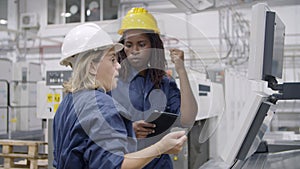 African American female factory engineer teaching employee