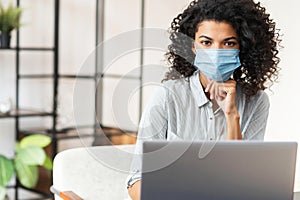 African American female freelancer wearing a mask