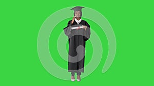 African American female graduate holding diploma and giving speech on a Green Screen, Chroma Key.