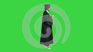 African American female graduate holding diploma and giving speech on a Green Screen, Chroma Key.