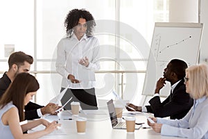 African-american female manager presenting report speaking at di