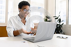 African-American female office employee using laptop