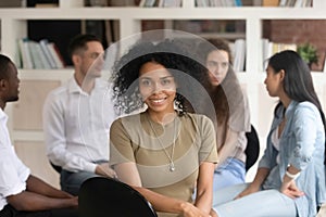 African american female psychotherapist looking at camera during group therapy photo