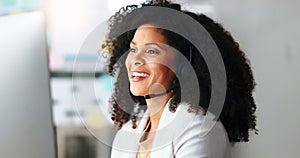 African American female sales or customer service agent working in a call centre, talking to a client with a headset. A