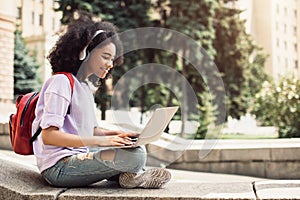 African American Female Student Using Laptop Learning Sitting Outdoor