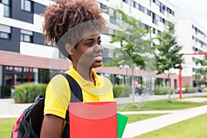 African american female student walking outdoor on campus