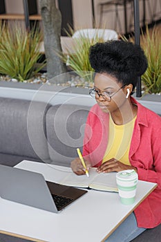 African American female student is watching online training webinar, education and work on Internet