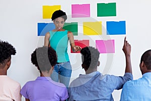 African american female teacher talking to students