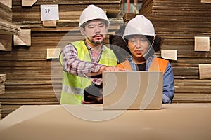 African American Female worker and colleague inspect paper storage warehouse